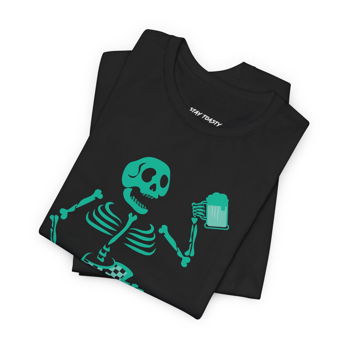 Black graphic tee with skeleton surfing a wave holding a beer. Front folded view.