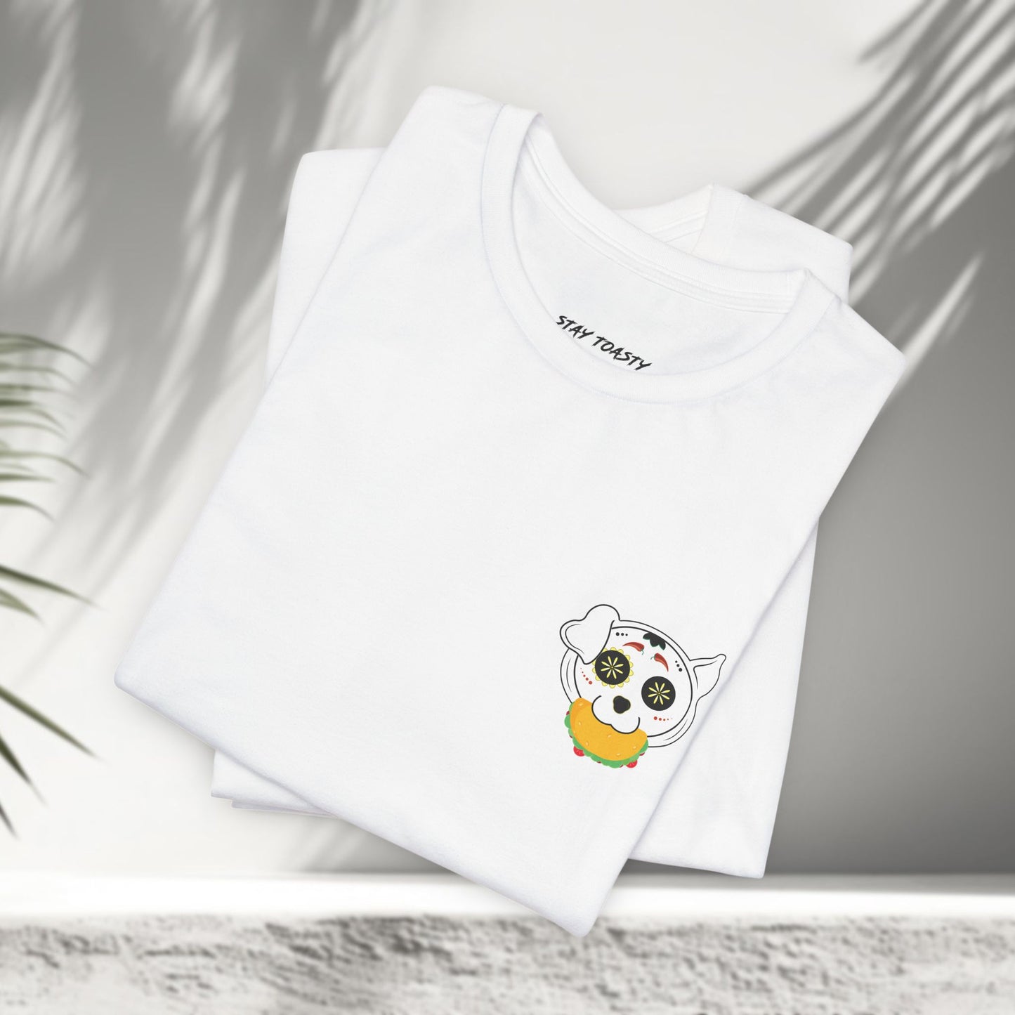 White Tacos and Doggos tees folded showing small sugar skull dog and taco chest print