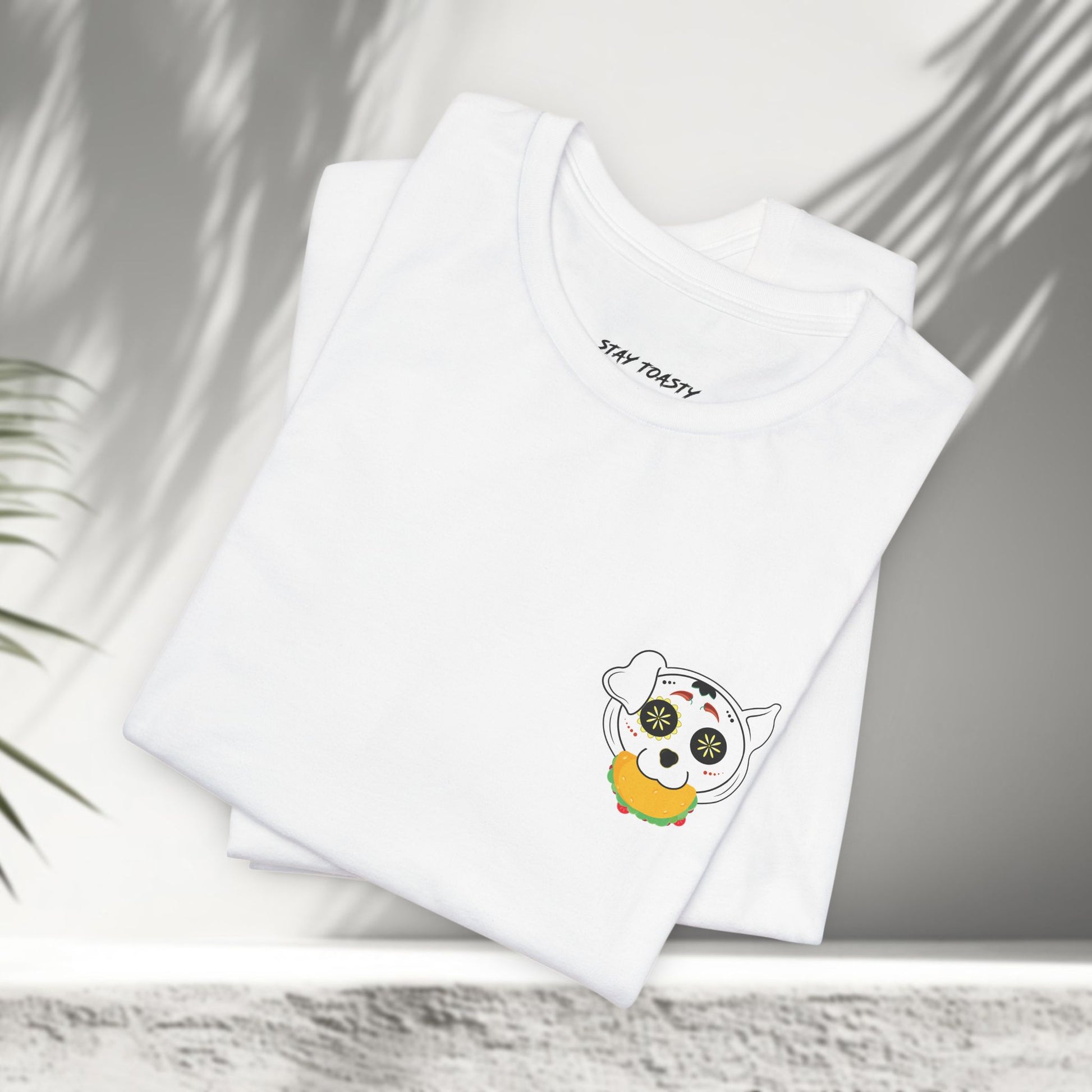 White Tacos and Doggos tees folded showing small sugar skull dog and taco chest print