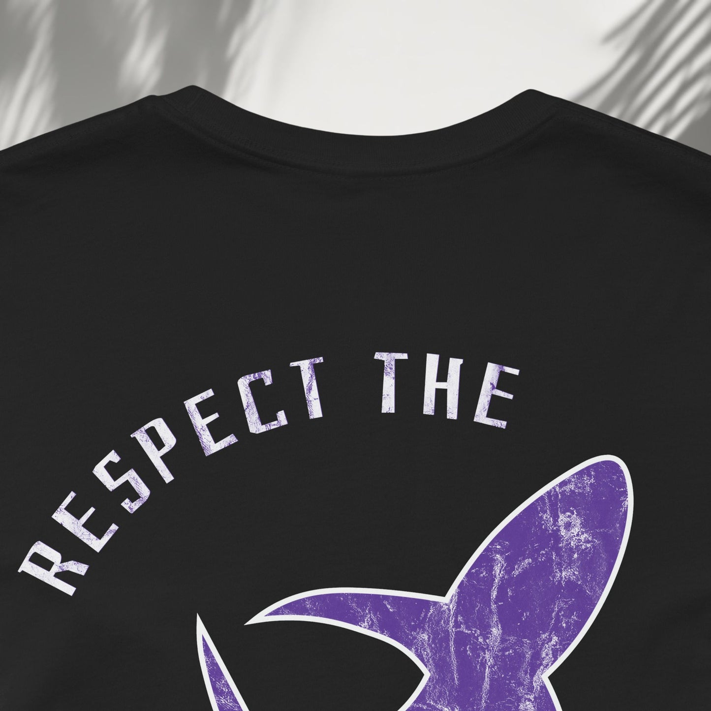 Respect the Locals tee detail shot of purple shark graphic and Respect The text back print