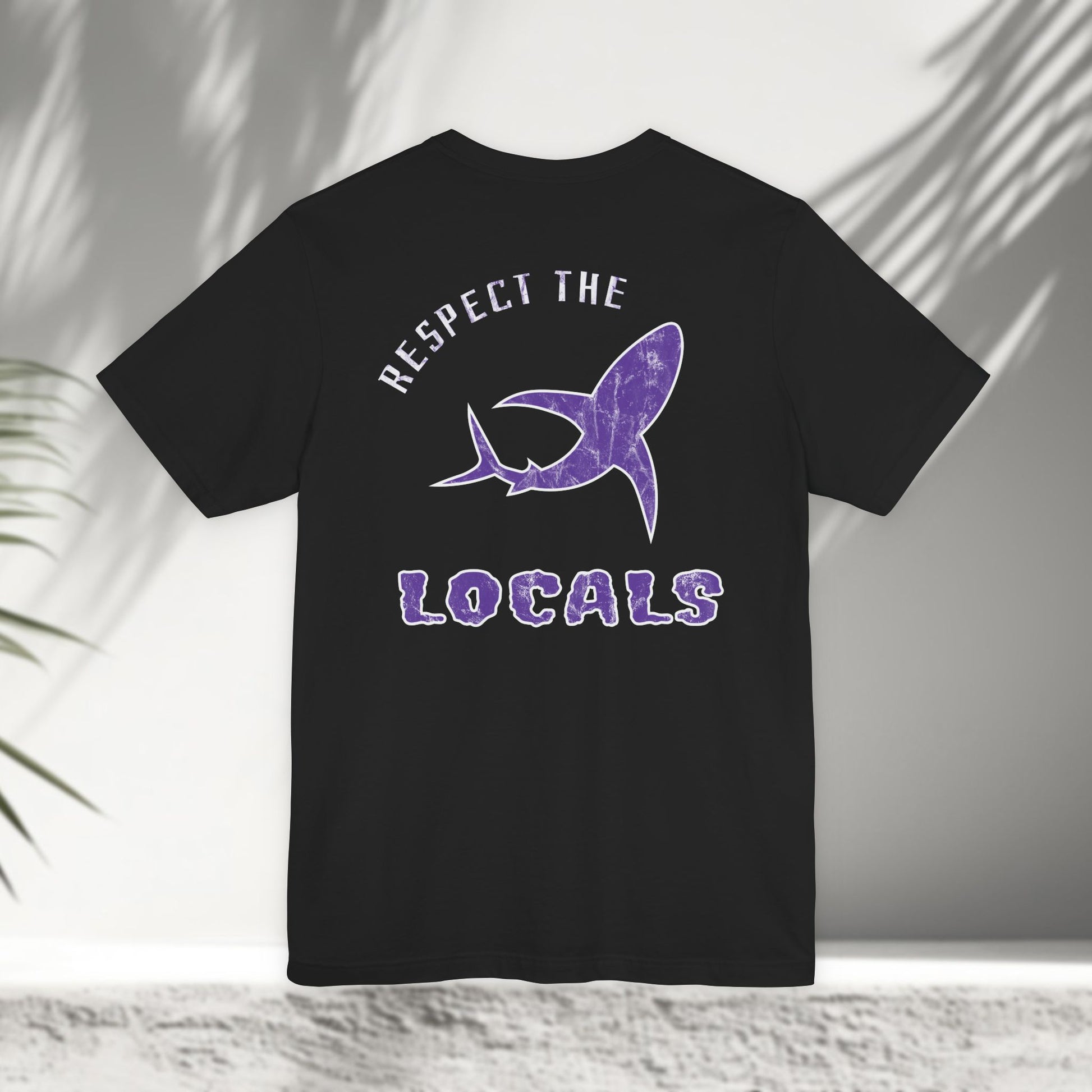 Black Respect the Locals tee flat lay showing purple shark graphic back print design