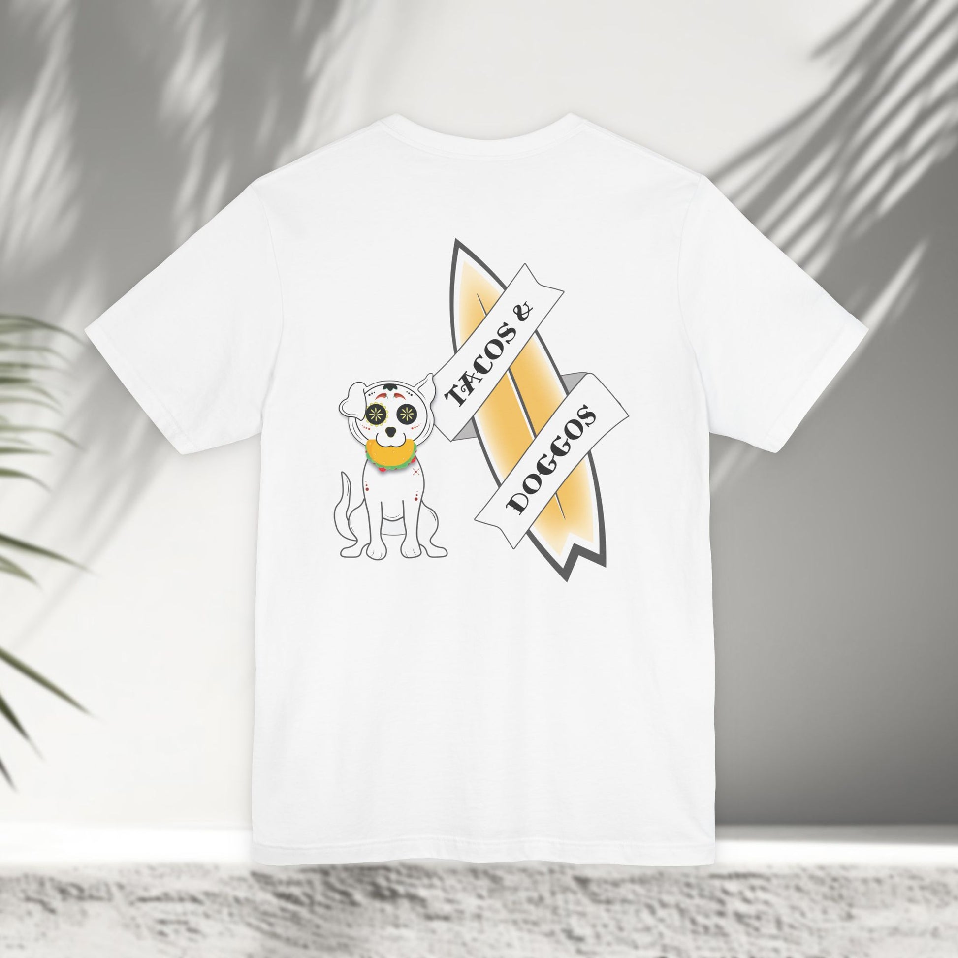 White Tacos and Doggos tee flat lay showing sugar skull dog with taco and surfboard back print design