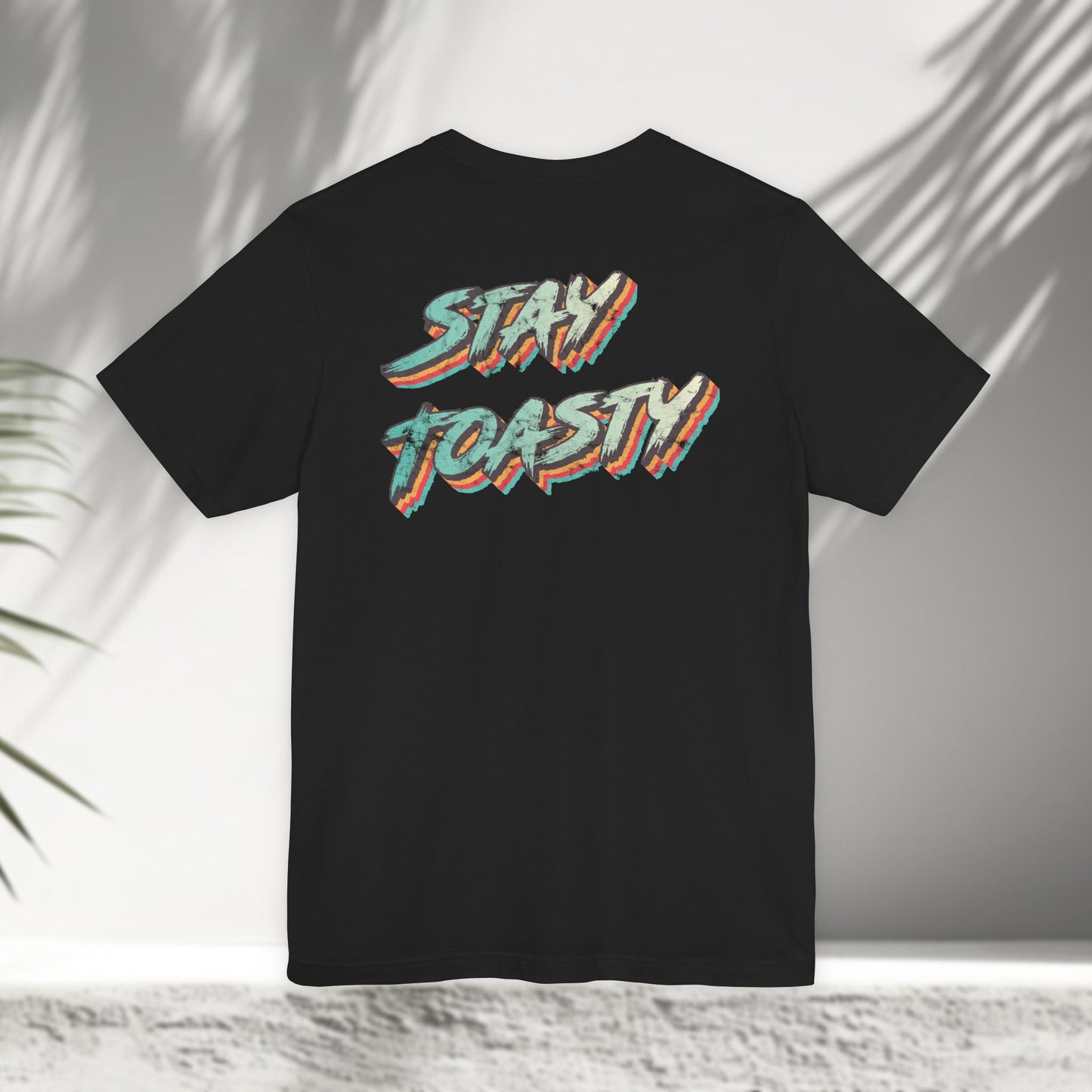 Black Vintage Toast tee flat lay showing colorful retro Stay Toasty typography back print