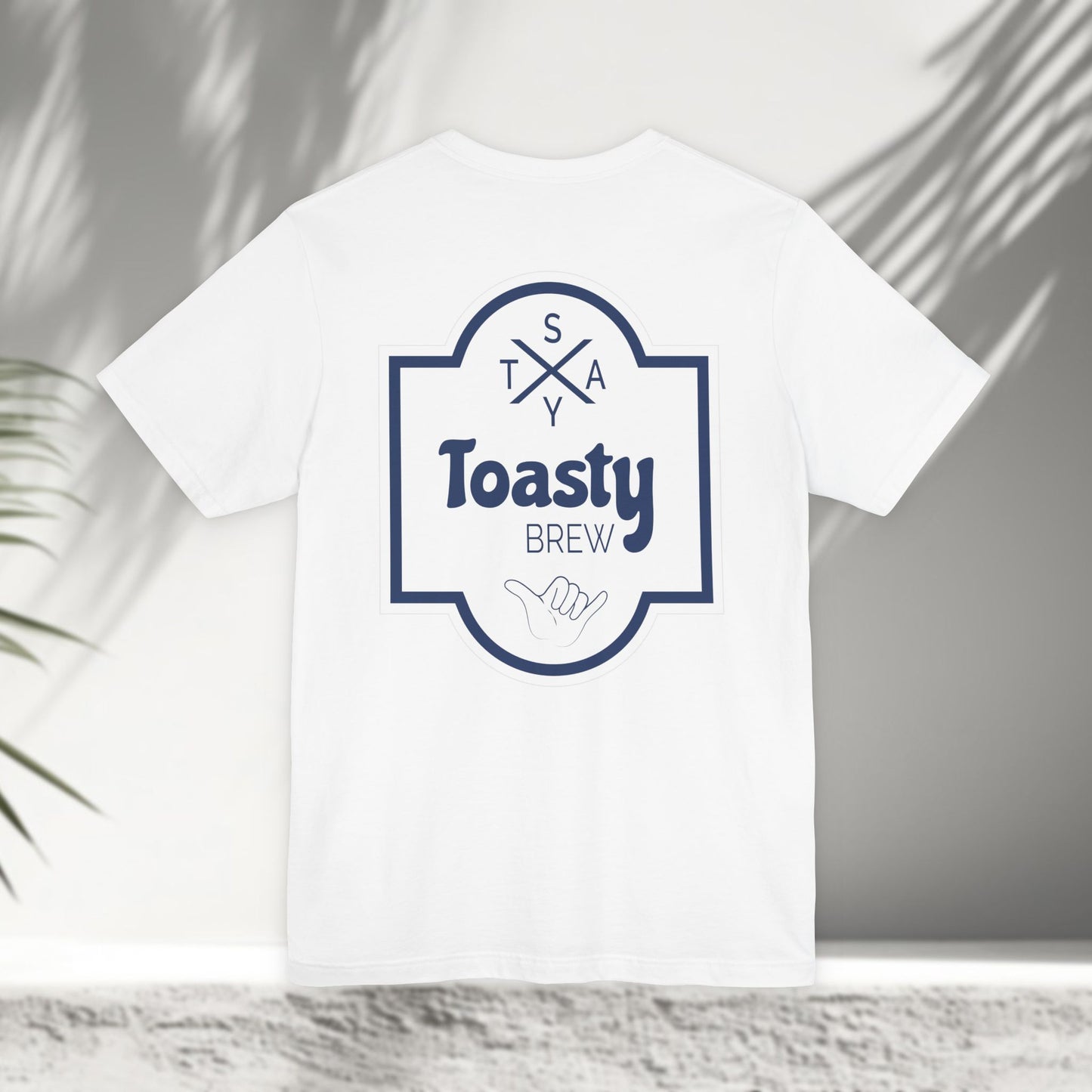 White Toasty Brew tee flat lay showing vintage beer label back print with shaka hand and Stay Toasty branding