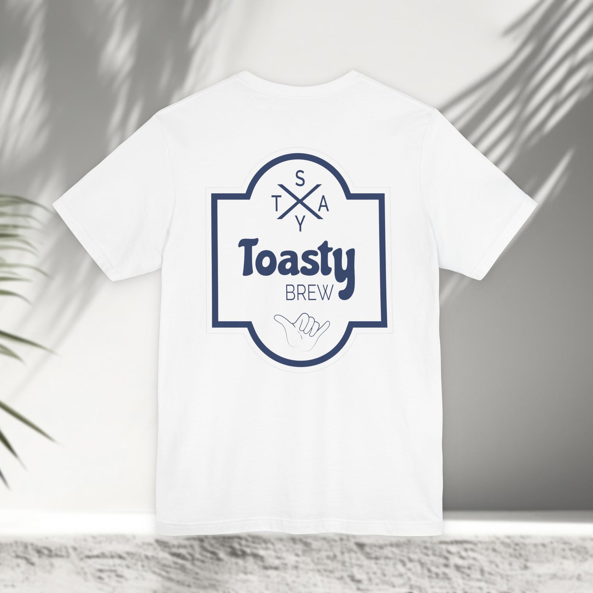 White Toasty Brew tee flat lay showing vintage beer label back print with shaka hand and Stay Toasty branding