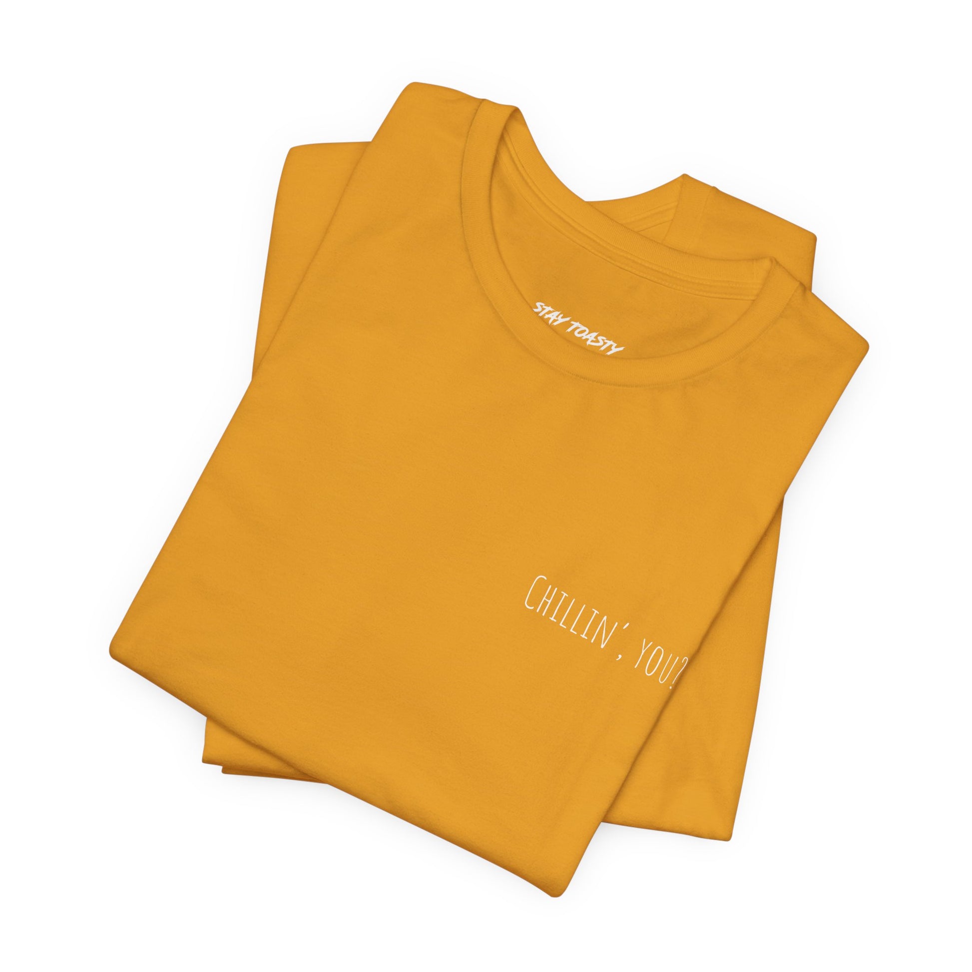 Folded mustard t-shirt with 'Chillin, you?' print on front chest.