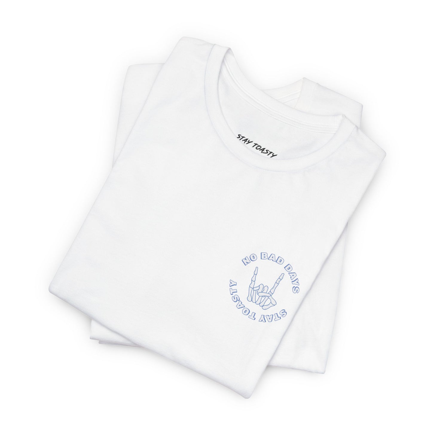 White graphic tee with skeleton hand with text "No Bad Days" and "Stay Toasty". Folded front view.