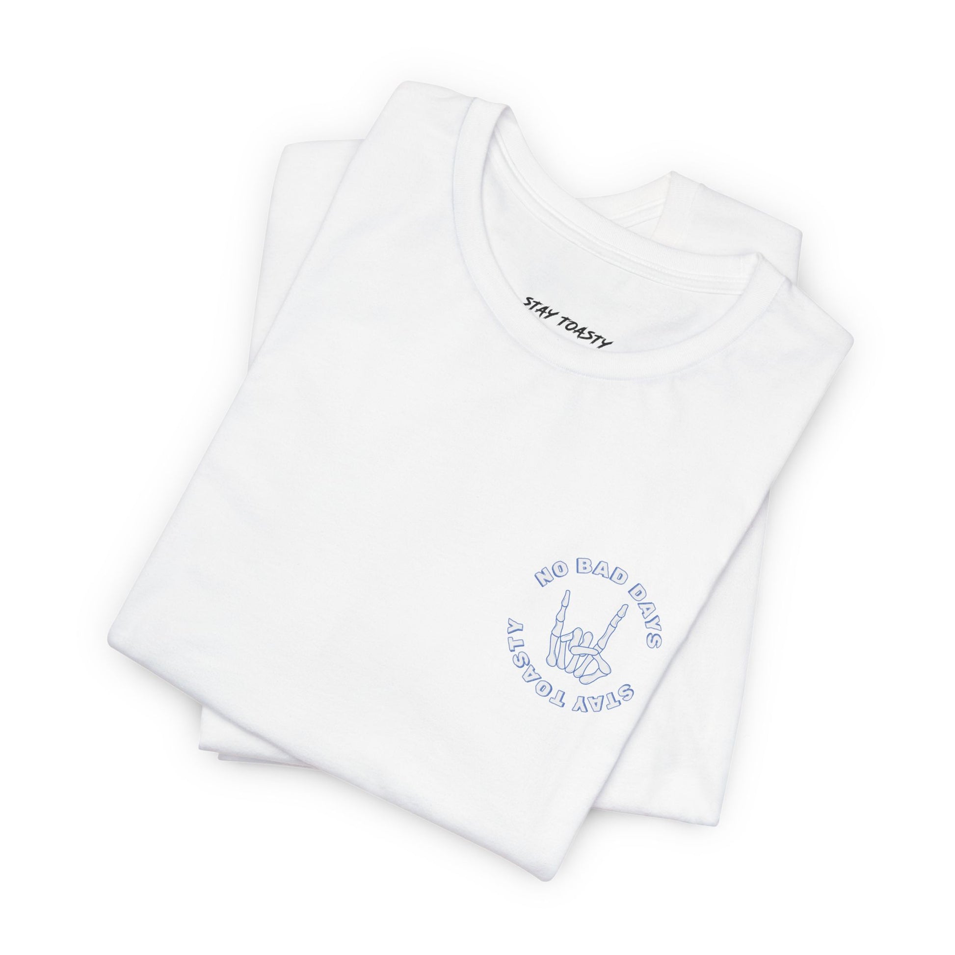 White graphic tee with skeleton hand with text "No Bad Days" and "Stay Toasty". Folded front view.