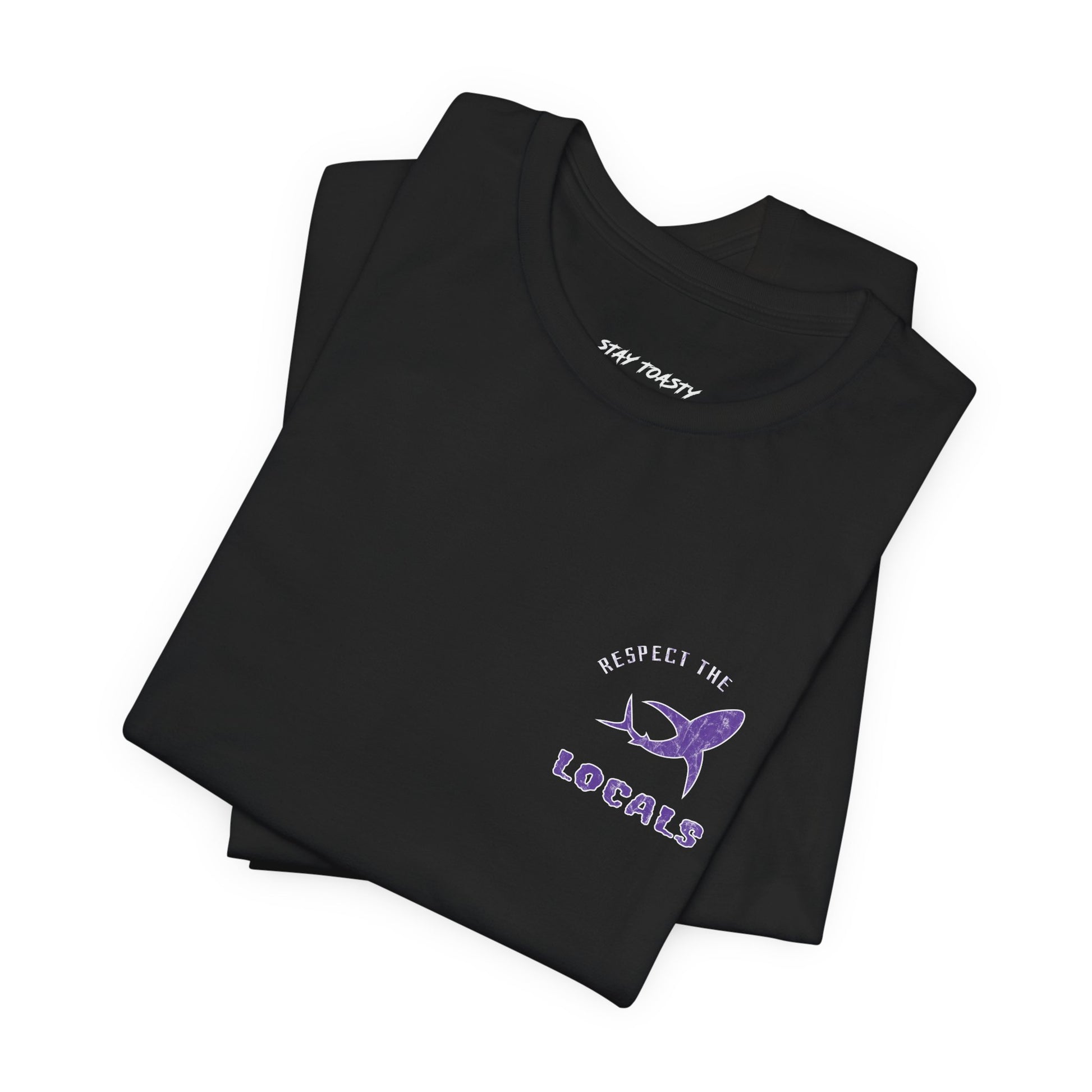 Black graphic tee with text "Respect the Locals" text around a shark graphic. Purple design with marble finish. Front view, folded. 