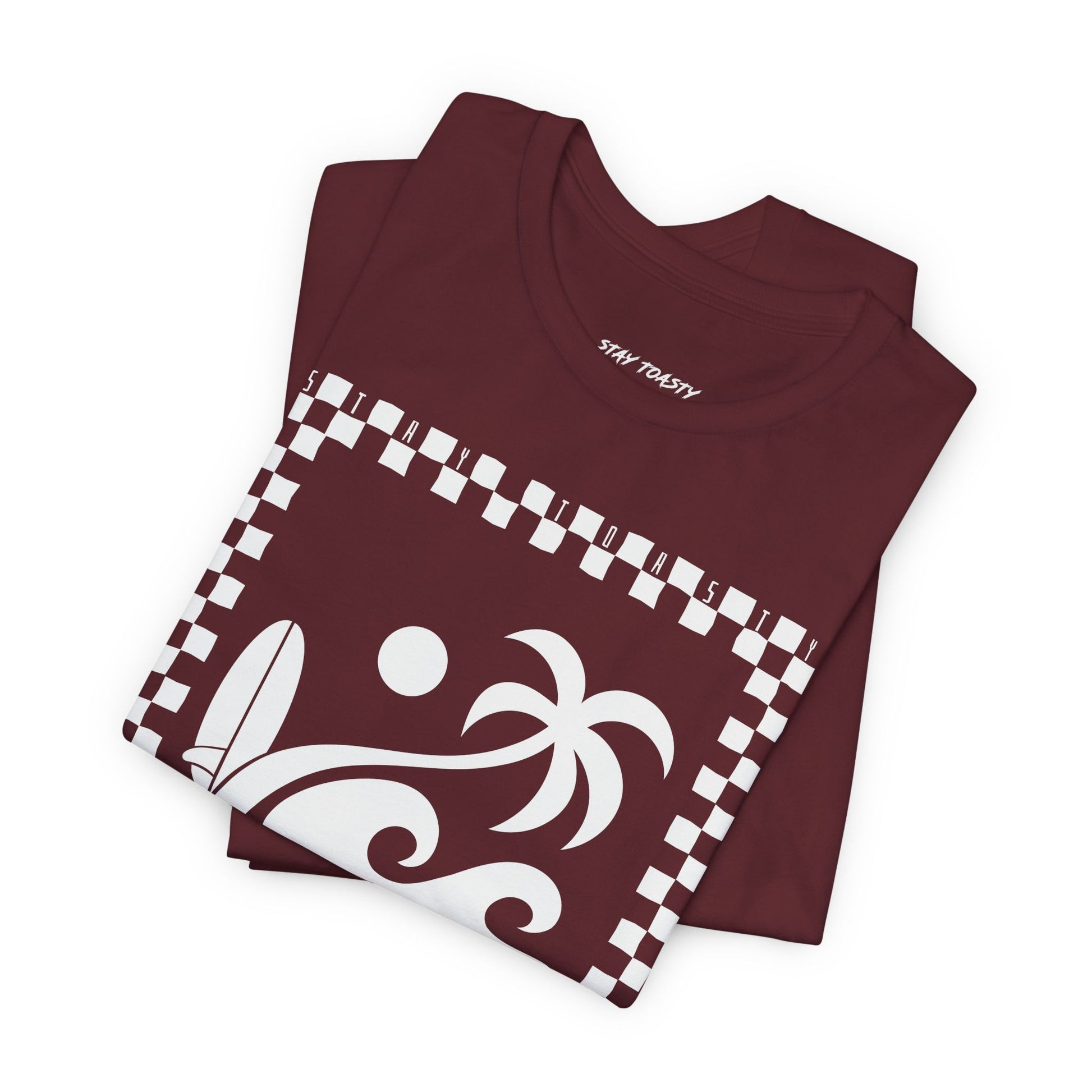 Maroon graphic tee with beach graphics. Outlined in a checkers. Large front graphic. Folded view.
