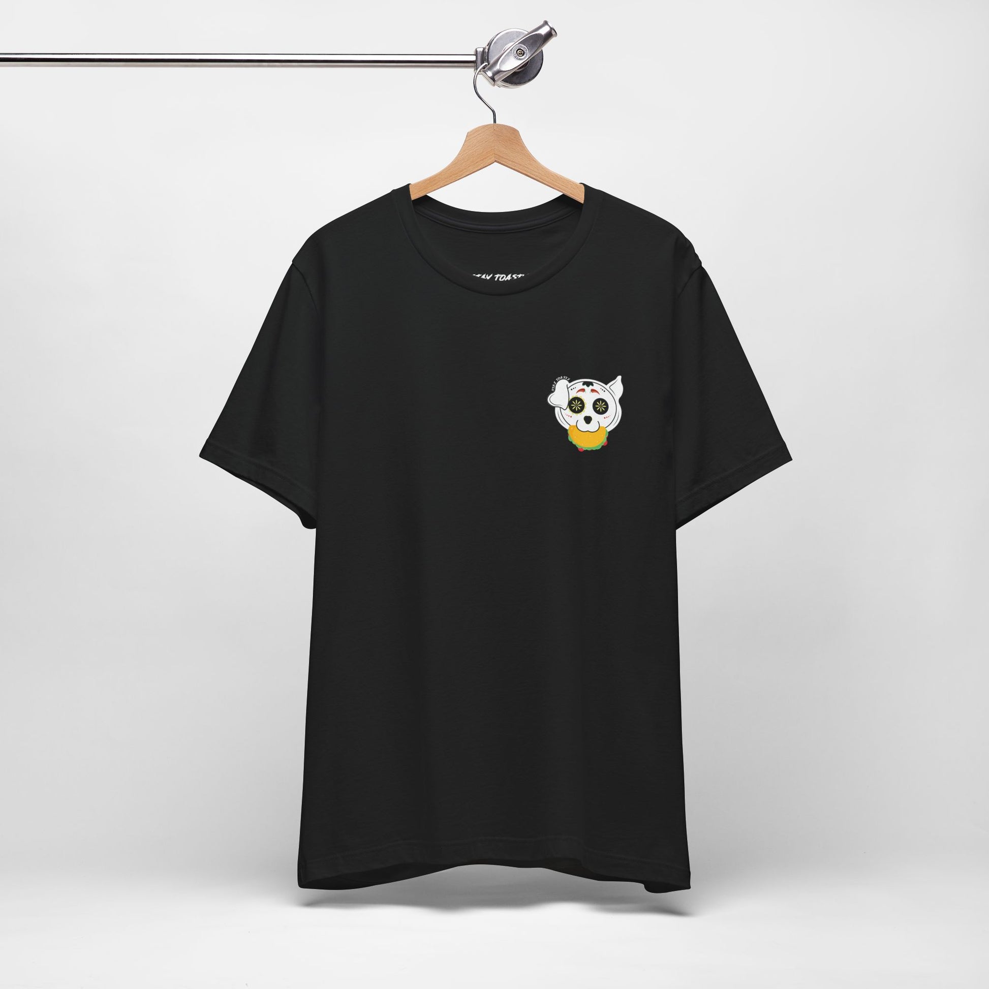 Black graphic tee with front chest design of sugar skull dog holding a taco. Front hanging view.