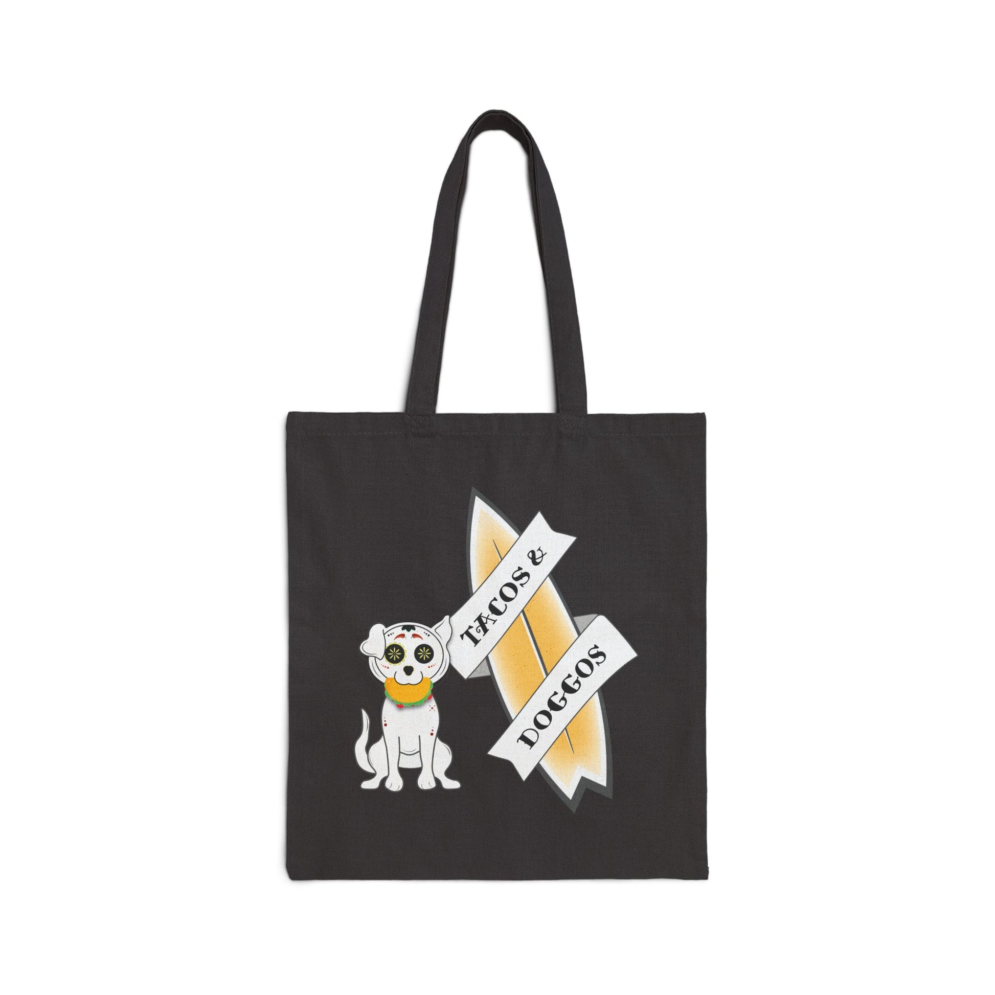 Black tote bag with a sugar skull dog with a taco in his mouth with text 'TACOS & DOGGOS'
