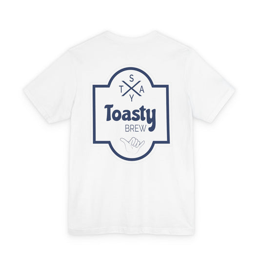 White graphic tee shown from the back. Simple graphic of a beer label that reads "Stay Toasty Brew" with a shaka hand.