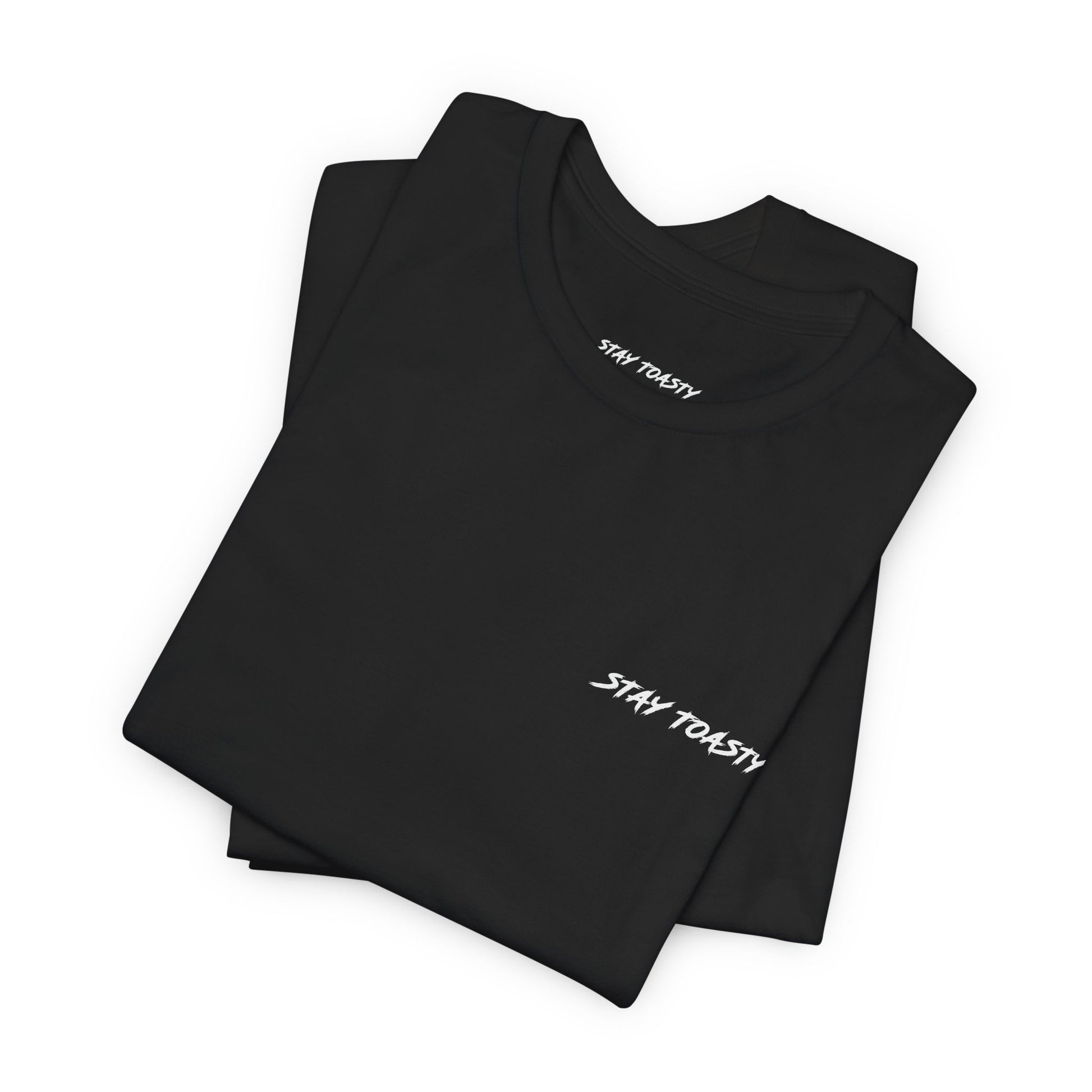 Folded black graphic tee with white front chest logo reading "Stay Toasty".