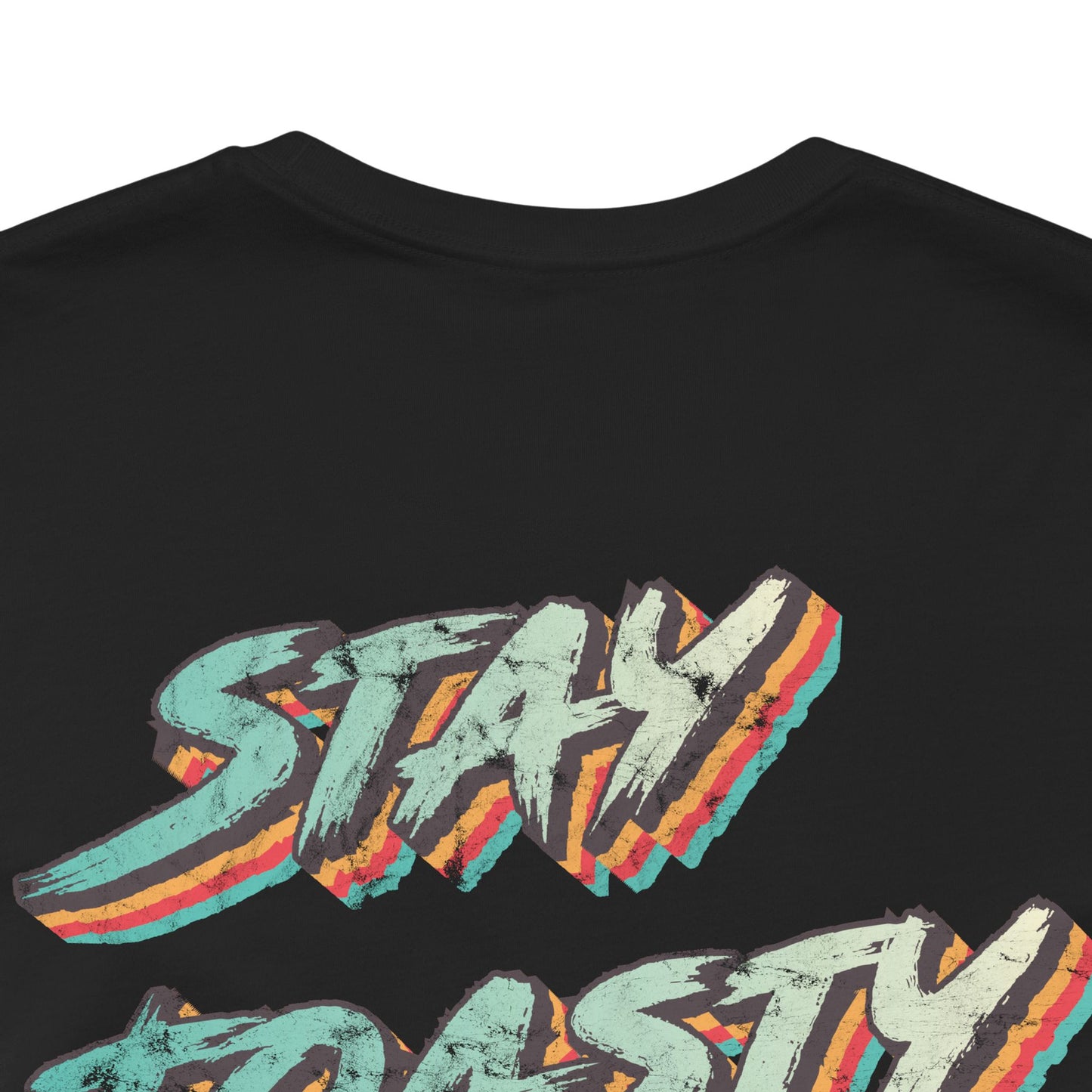 Close up of back graphic of black tee with vintage/retro text 'STAY TOASTY" 