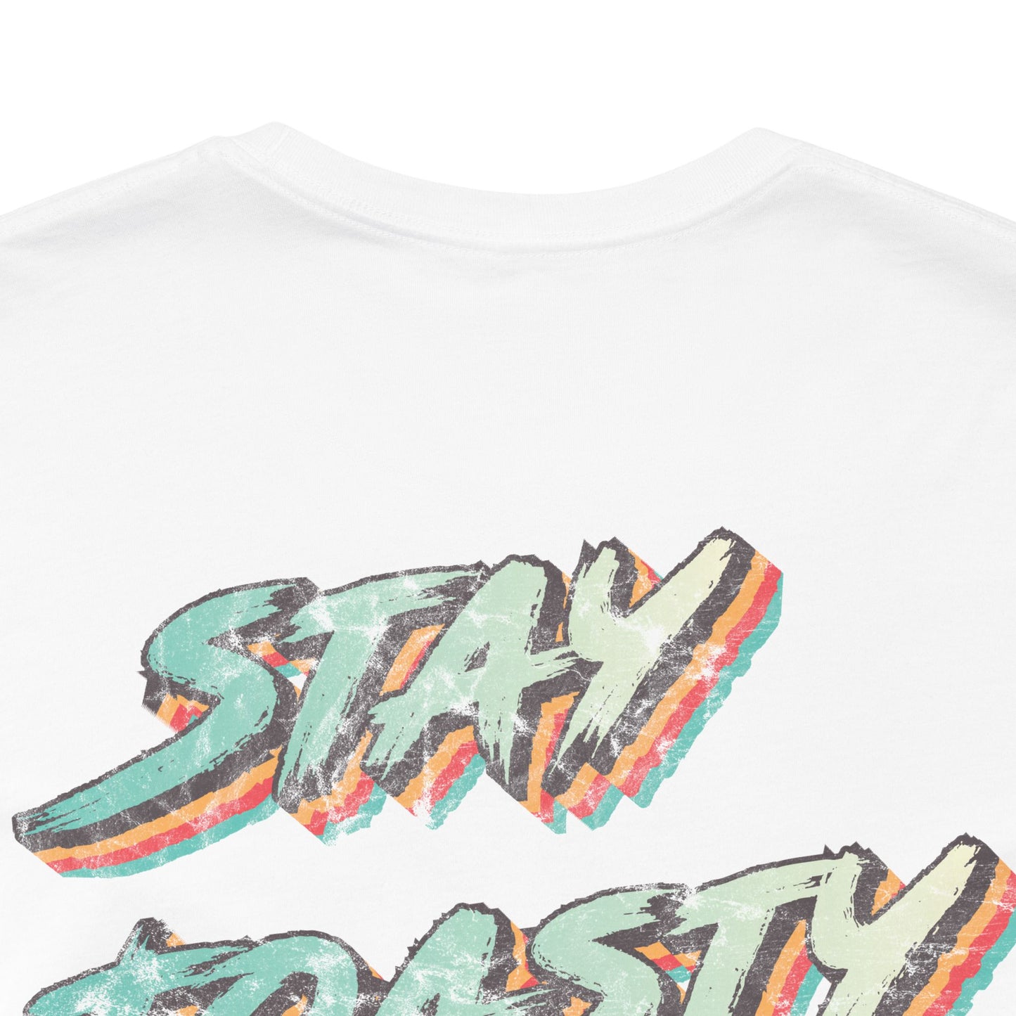 Close up of back graphic of white tee with vintage/retro text 'STAY TOASTY" 